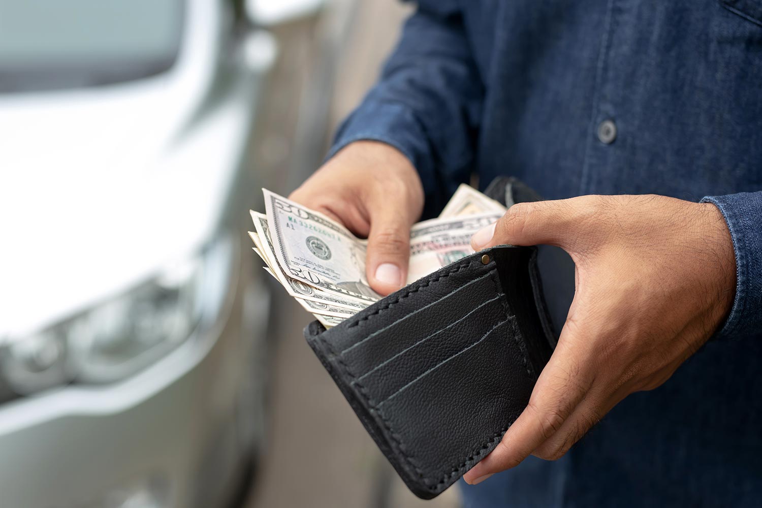 A wallet with cash being opened