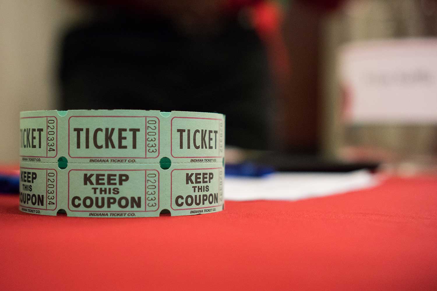 close-up of a large roll of raffle tickets on a tabletop