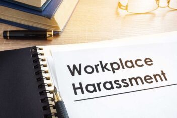 A letterhead in a spiral notebook with the words "workplace harassment"