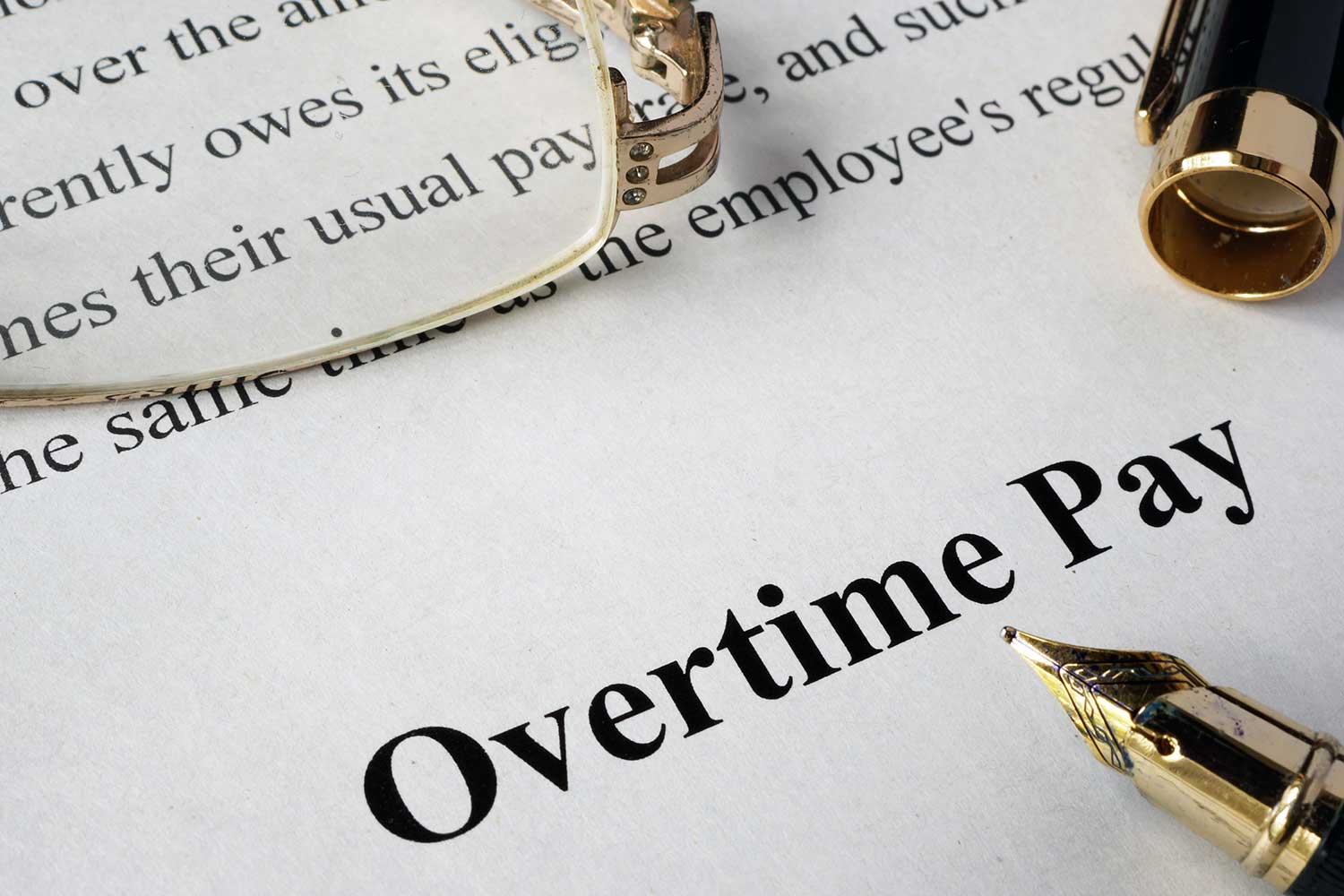 Overtime pay concept written on a paper.