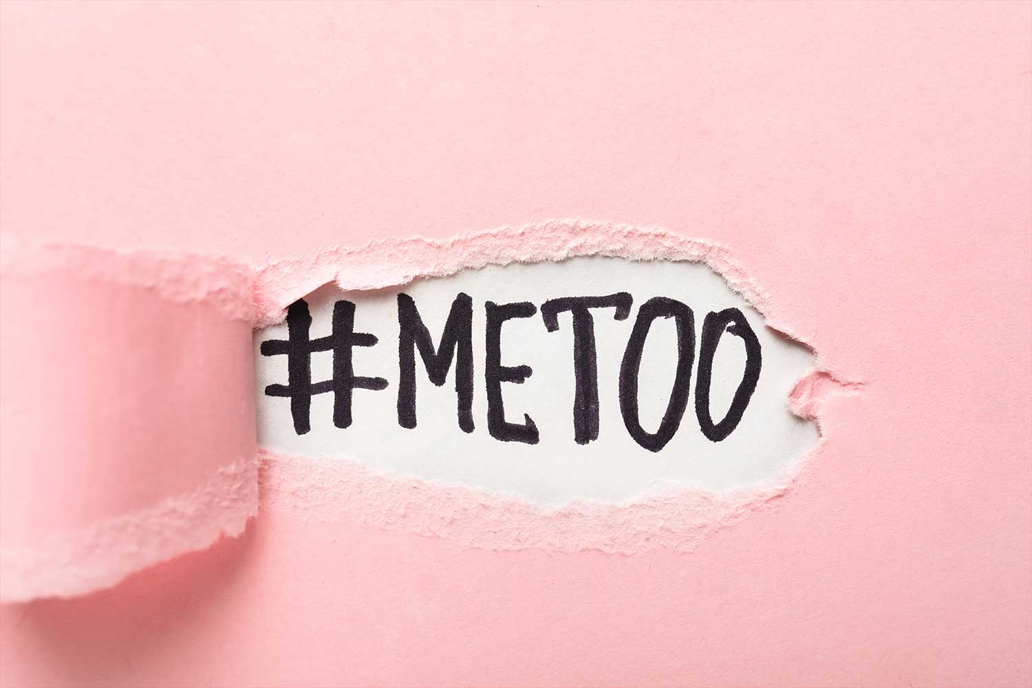 pink paper ripped to show "#METOO" underneath