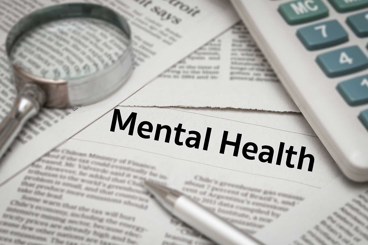 A collection of newspapers. Prominent headline reads: Mental Health