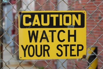 A sign reads: Caution watch your step