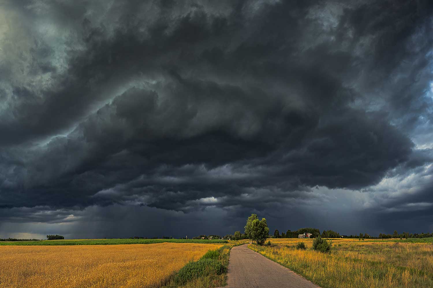 Dark storm clouds above a country road