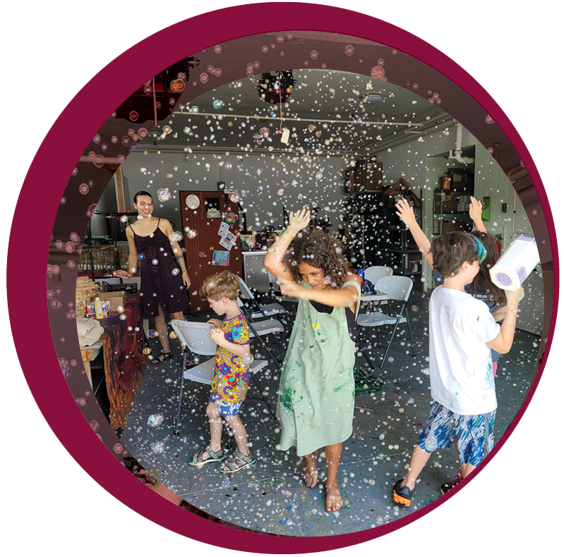 children dancing and playing with bubbles