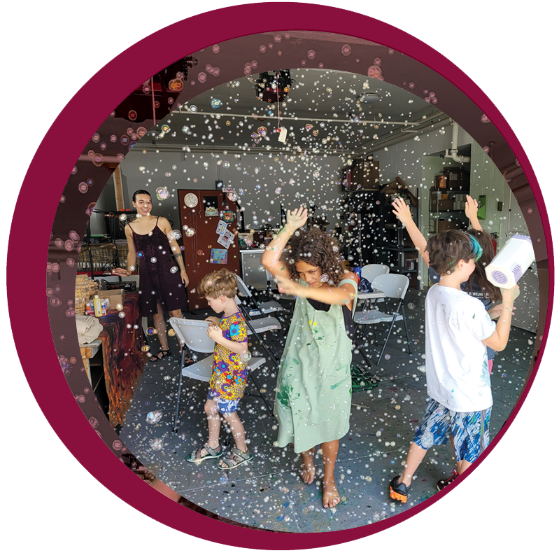 children dancing and playing with bubbles