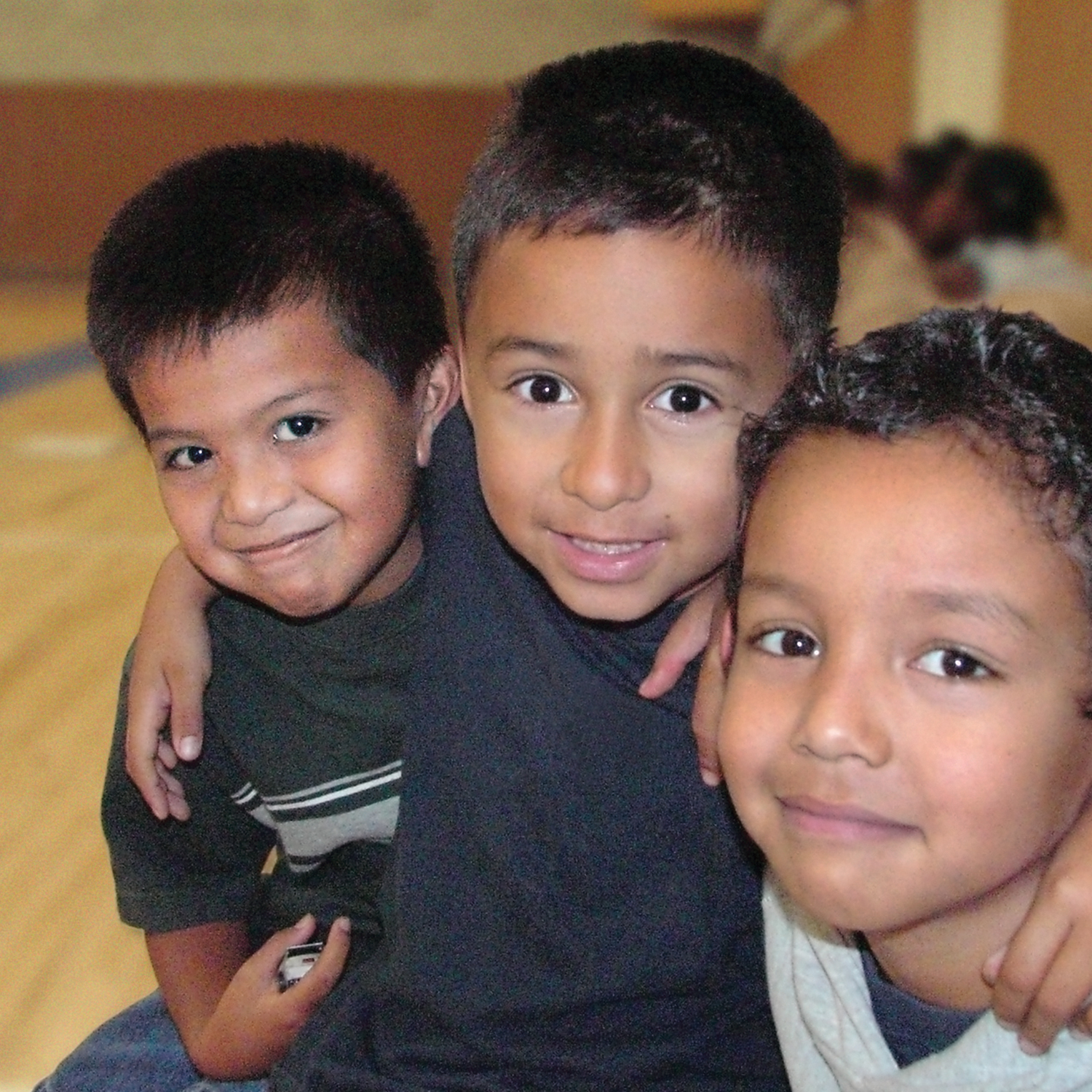 Three boys in a gymnasium