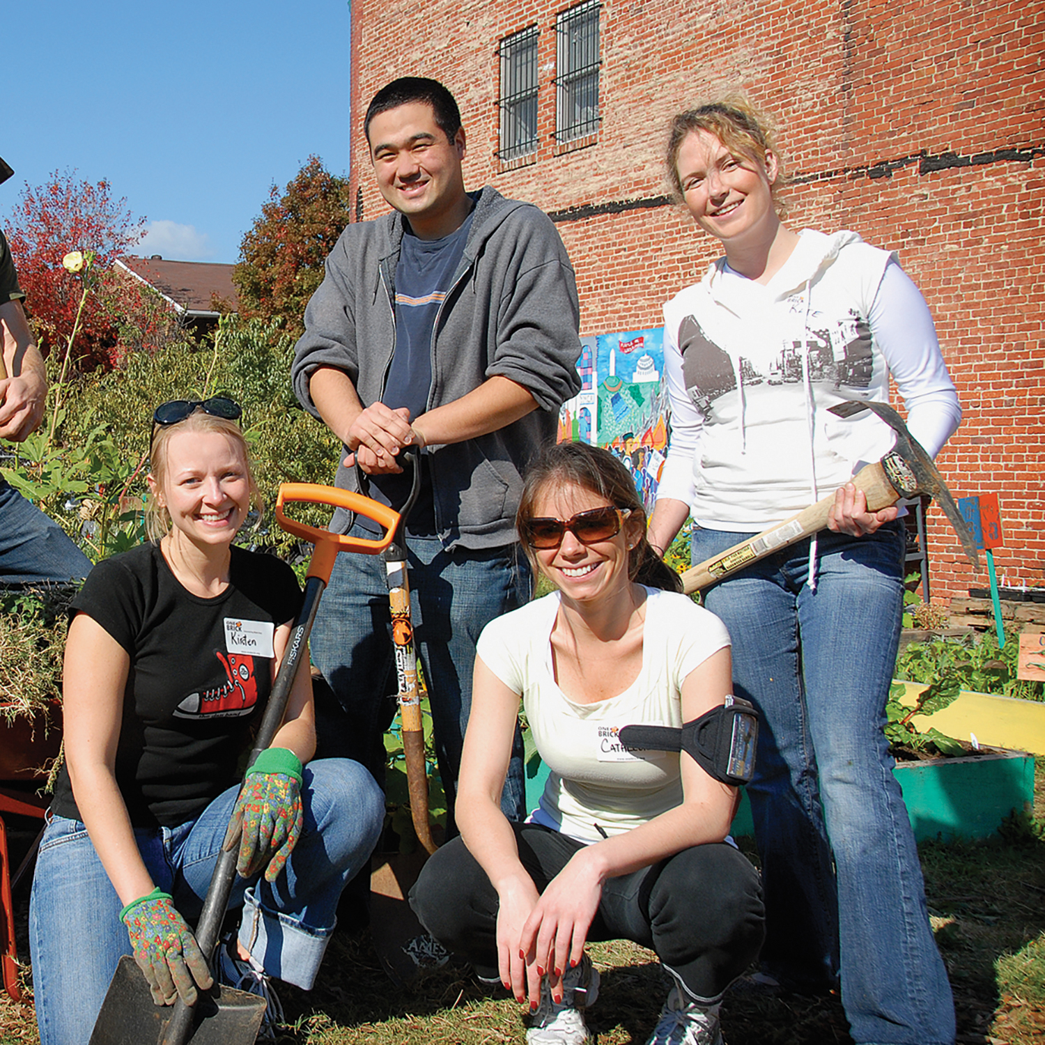 a group of young adults with garden tools
