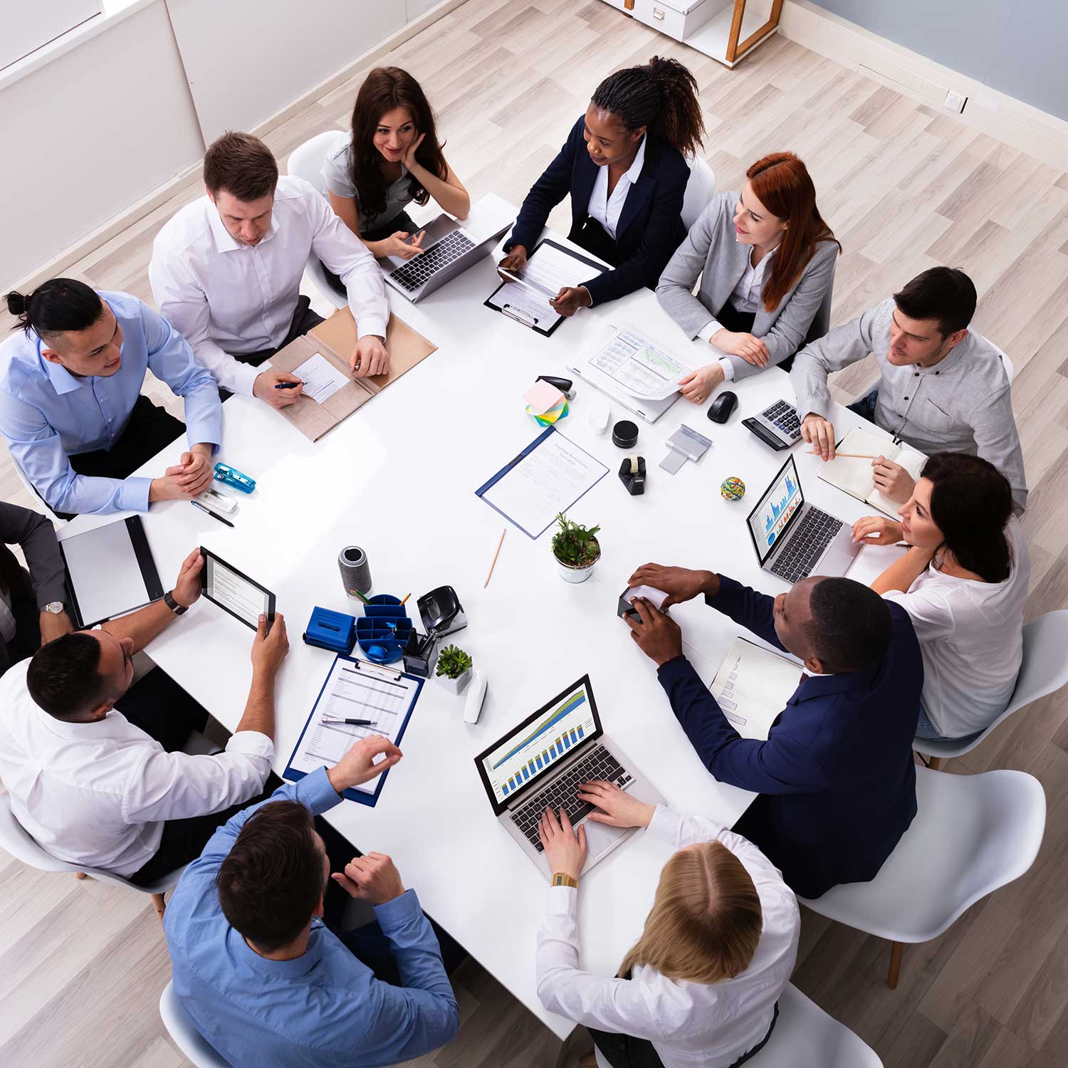 a group of business people at a meeting table viewed from above