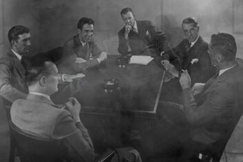 Men at a table in a smoke filled room