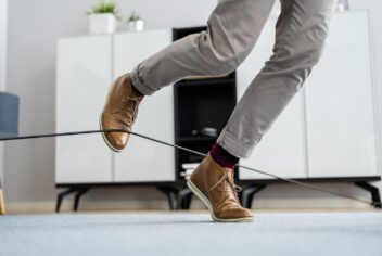 a person tripping on an electrical cord