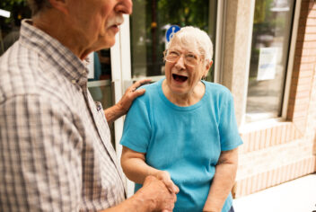 two smiling people shaking hands