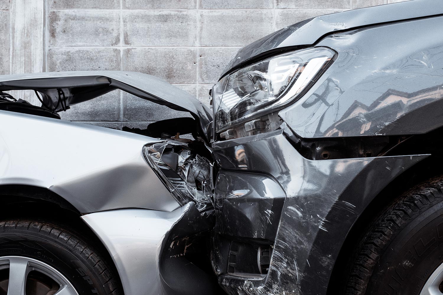 Front end of two cars that have been in a collision