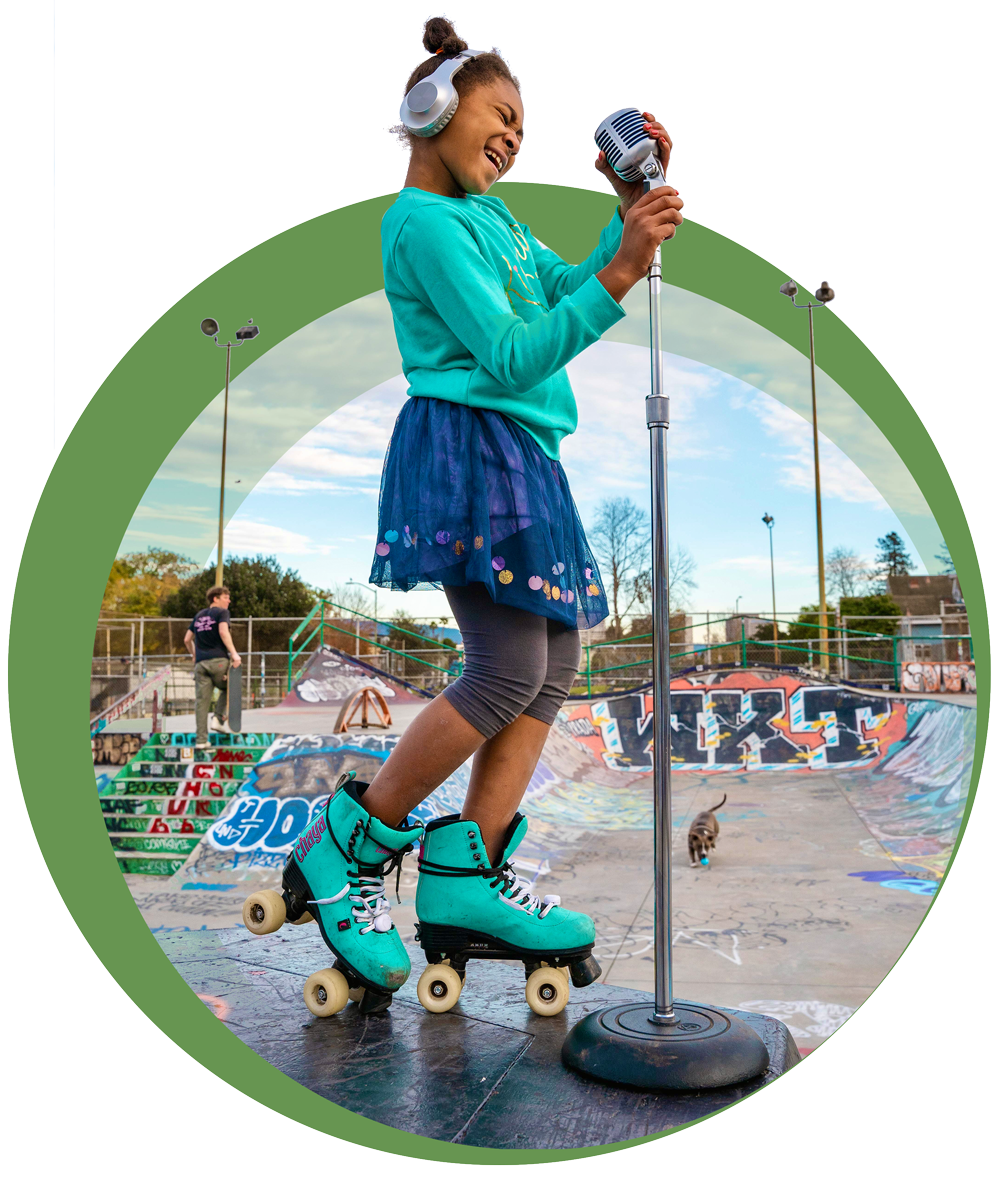 A girl on roller skates singing into a microphone