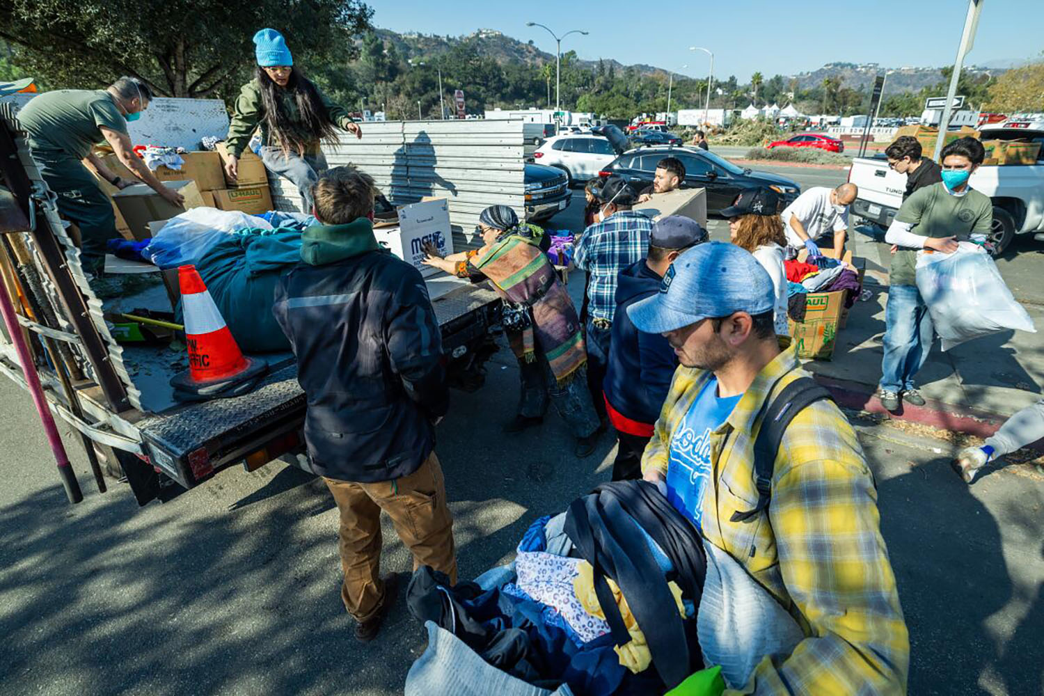 people load donations on a truck in a parking lot