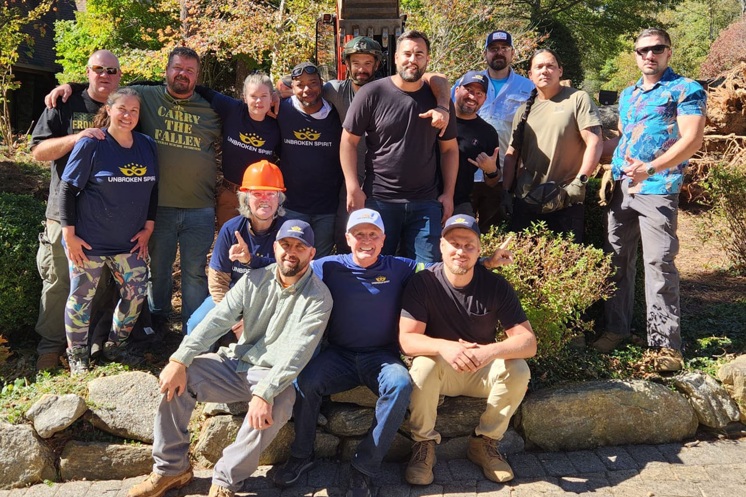 a group of people posing for a picture in work clothes