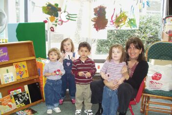 children and teacher in preschool setting