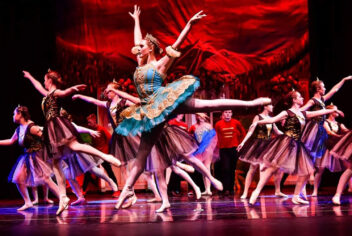 a ballet performance with multiple dancers in costume