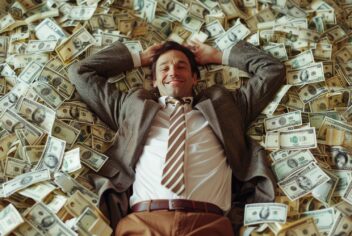 man sleeping on a bed of money