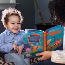 a person reading a book to a small child