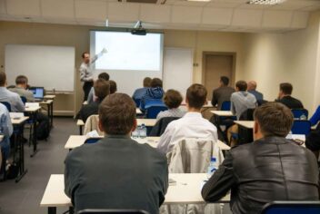 a group of adult students watching a classroom presentation