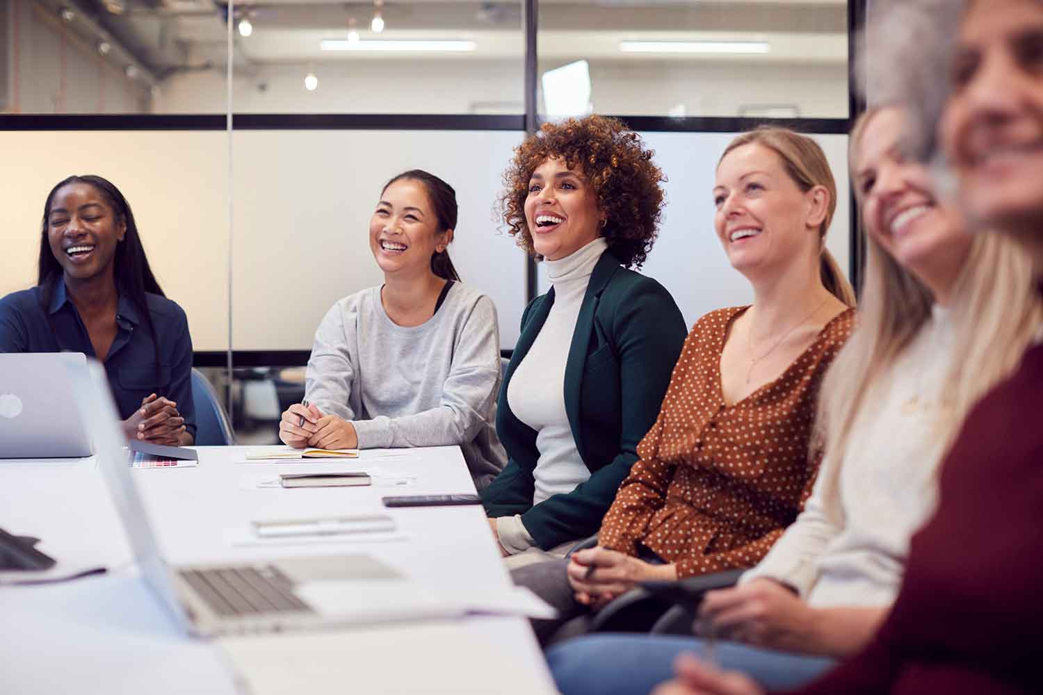 a group of women listening to a speaker