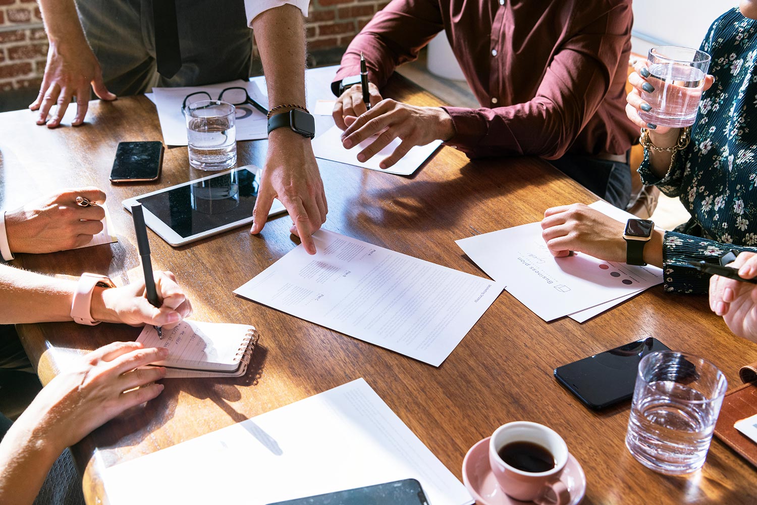 People sitting around a table looking at business papers
