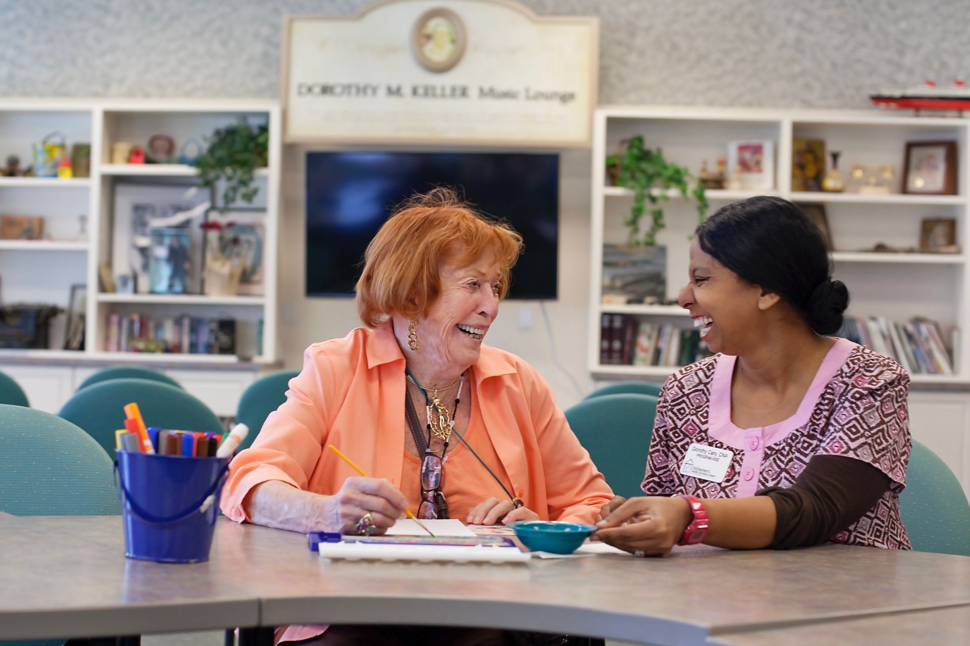 two women sitting at a table talking