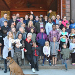 a group of people standing on steps outside a building