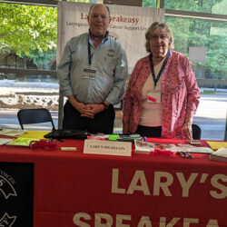 two people standing by an information table