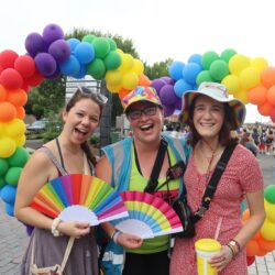 people outside with lots of rainbow decorations