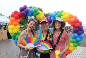 people outside with lots of rainbow decorations