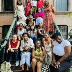 A group of people sitting on a stoop