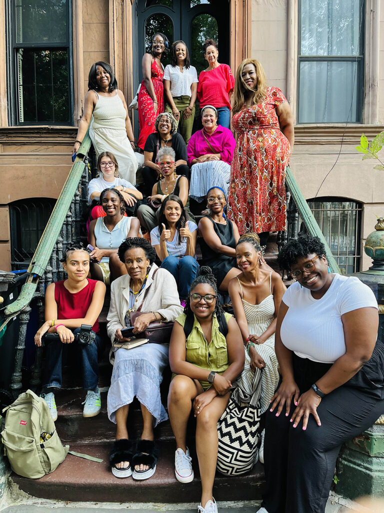 A group of people sitting on a porch stoop