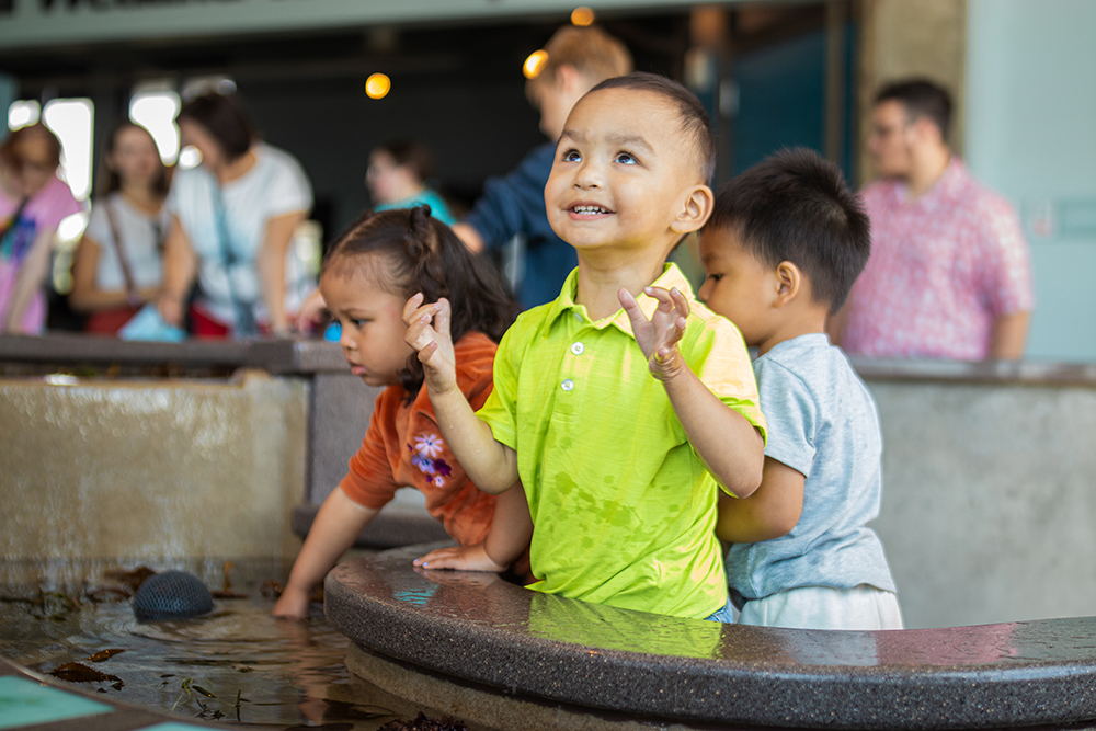 a young child looking upward and smiling