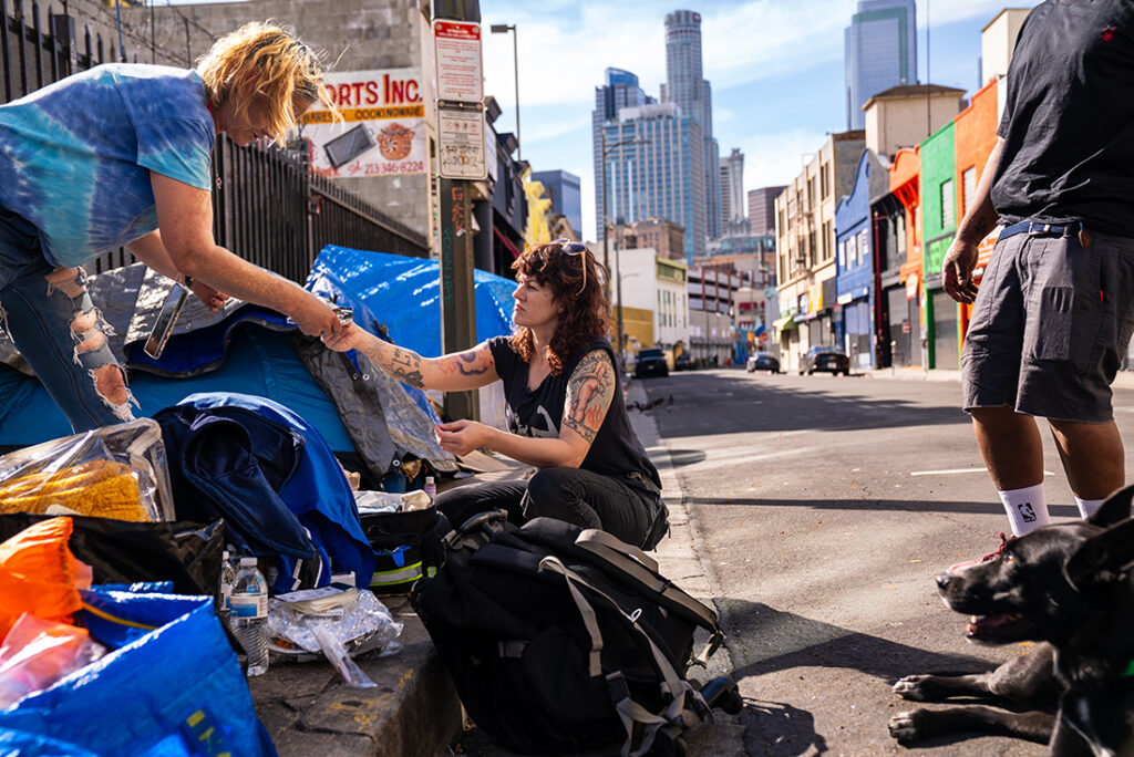 a person handing an item to a person in need