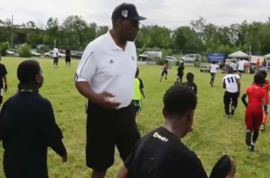 kids and a coach on a football field