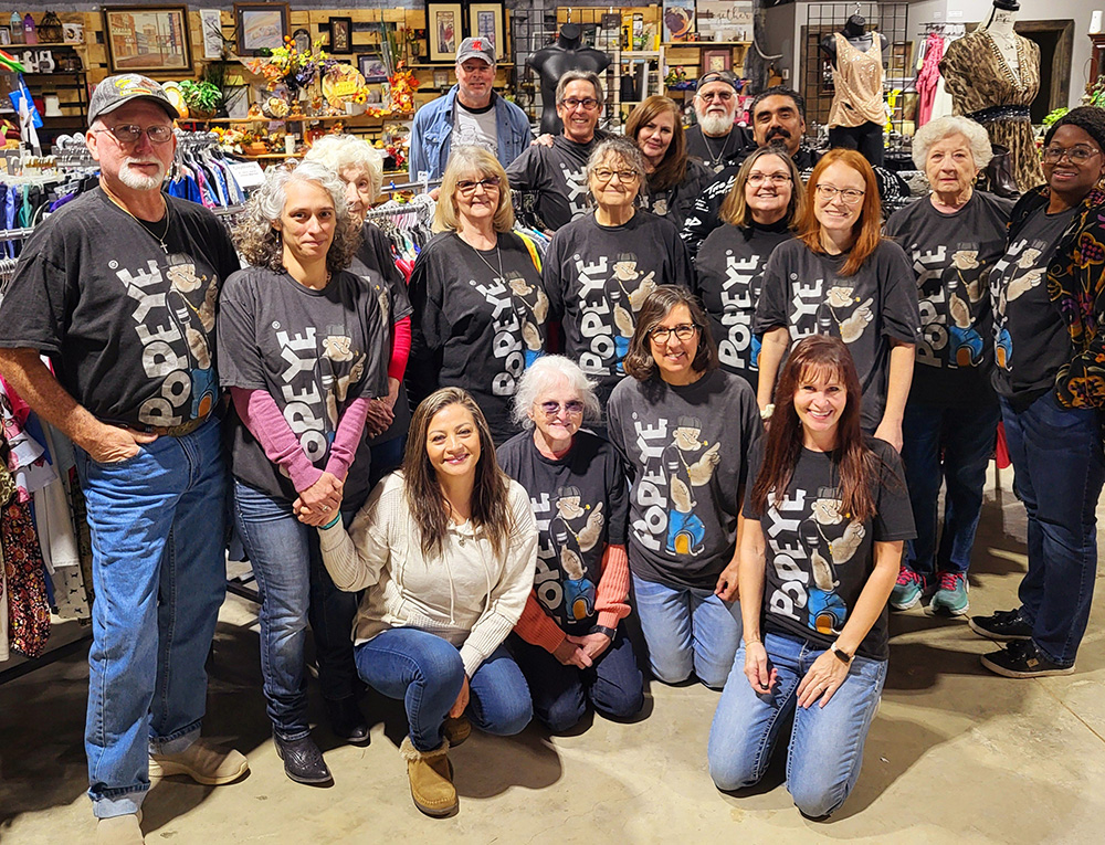a group of people wearing matching t-shirts in a store