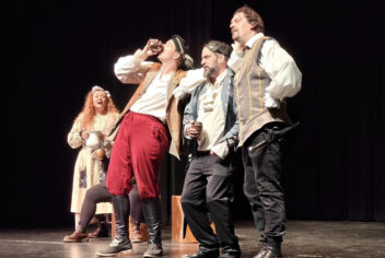 people on a stage in costumes