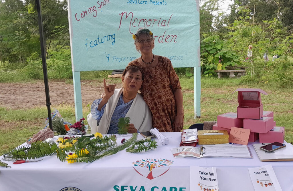 two people at a table in a garden