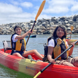 two people rowing a kayak