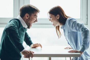 two angry people facing each other yelling