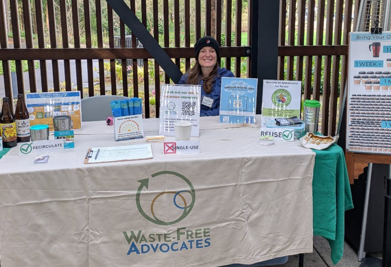 a person sitting at a table that says Waste-Free Advocates