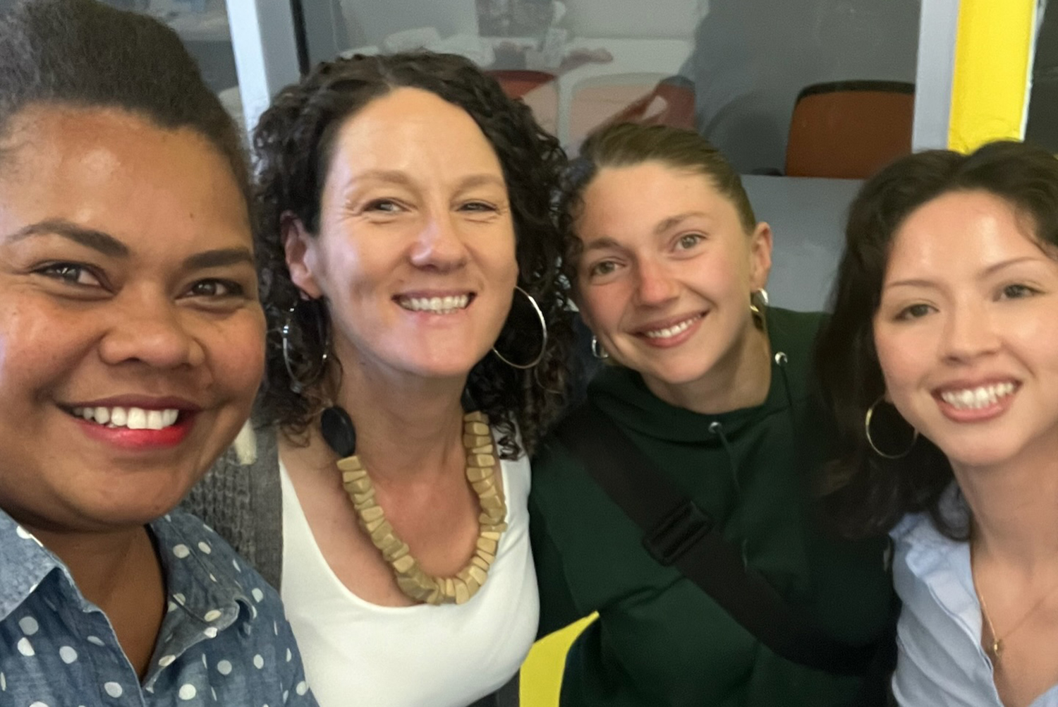 four people smiling