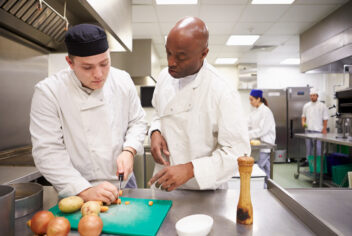 a person in a restaurant kitching being trained