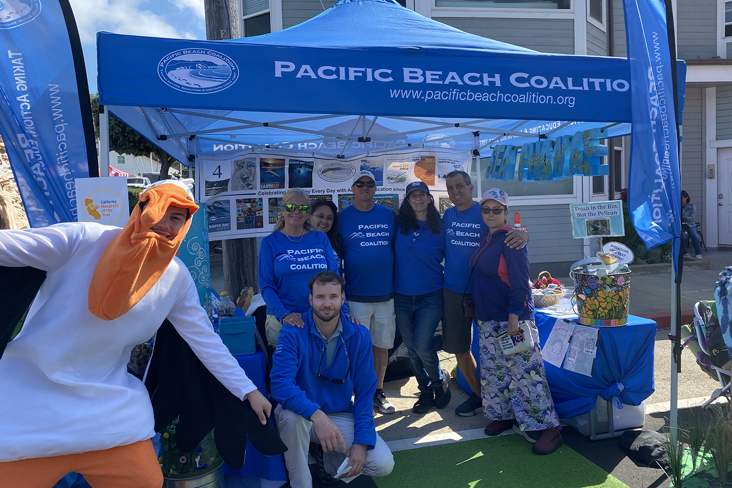 people standing under a blue tent