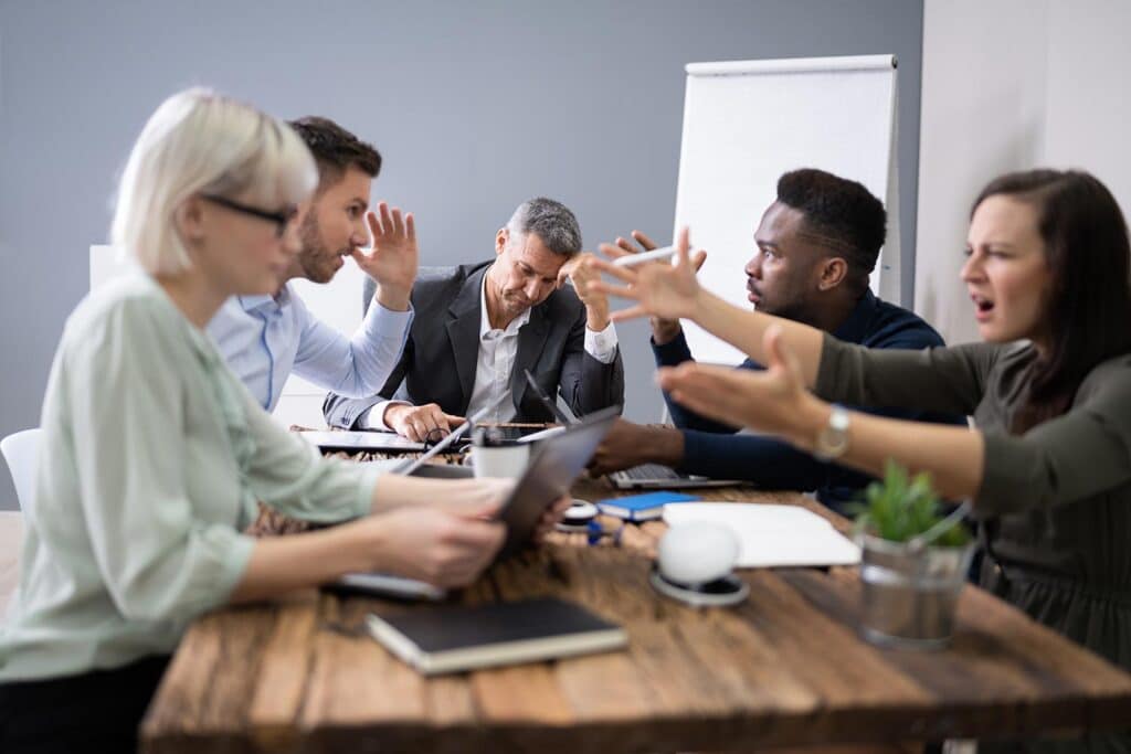 people at a meeting table arguing