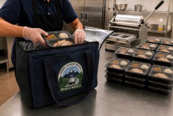 prepared meals in a kitchen being packed into a cooler