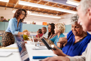 people on laptops at a community center
