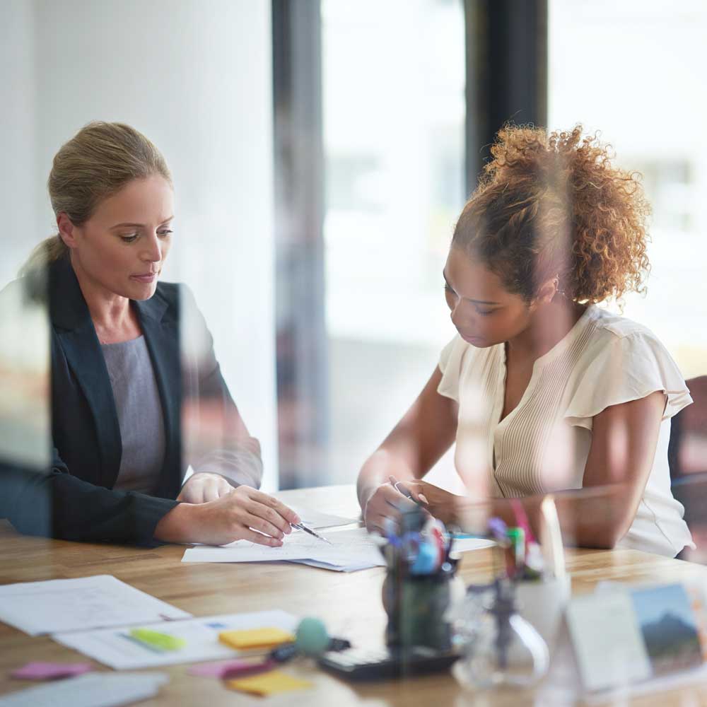 employees at a table reviewing documents